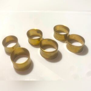 Six Brass Oval Napkin Rings with Beige Napkins